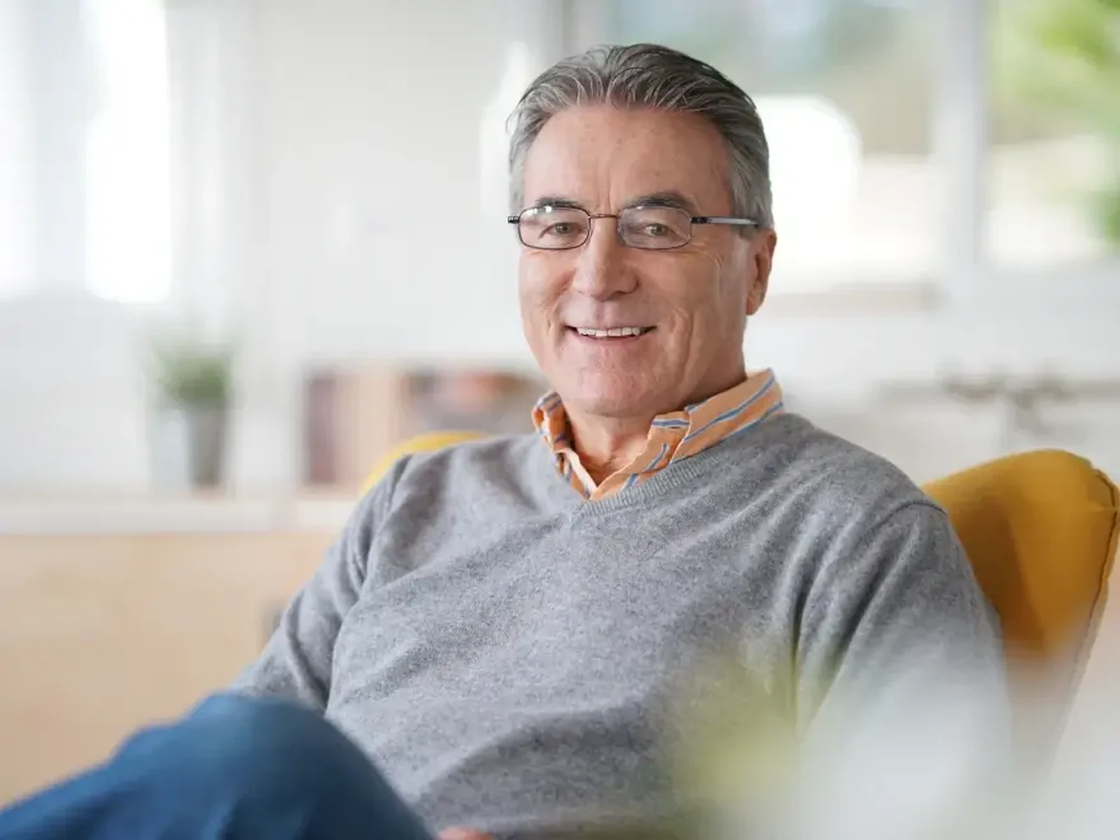 A smiling senior man relaxing at home