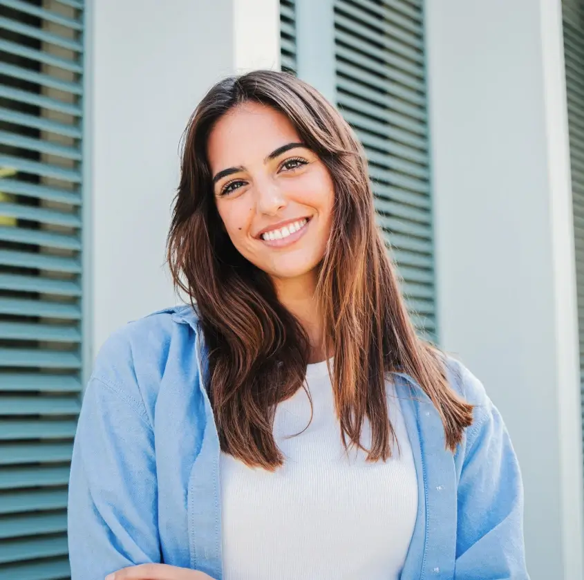 A smiling young woman outdoors